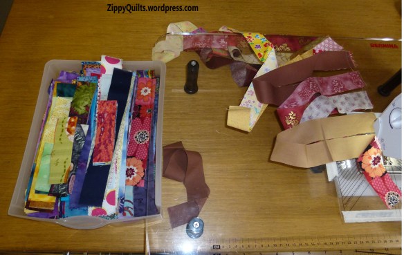 A bin of scraps being made into a long strip